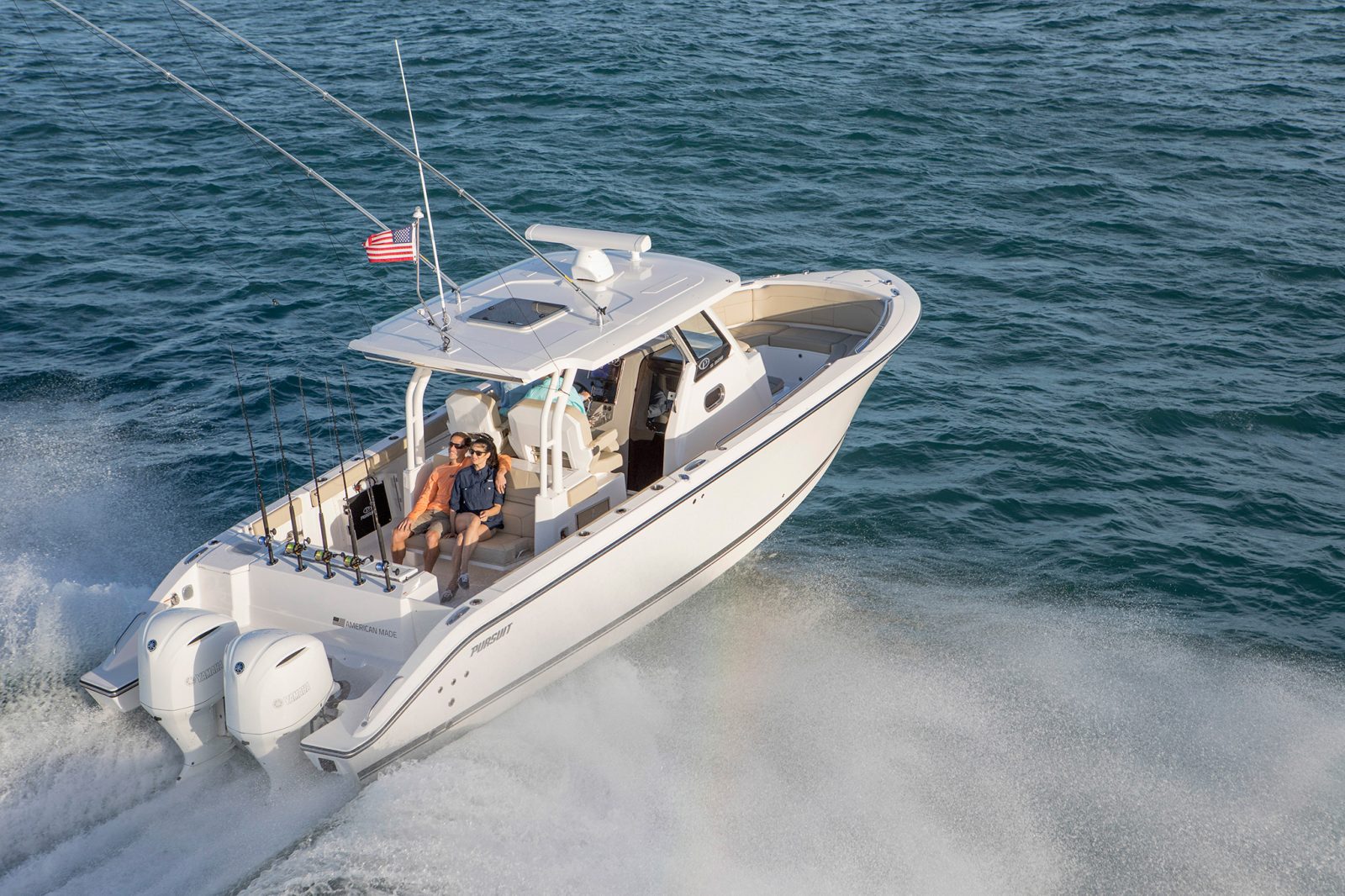 Pursuit Sport S 328 racing out to the open ocean for a day of fishing.